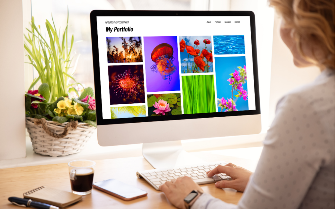 Artist viewing colorful digital portfolio on a desktop computer