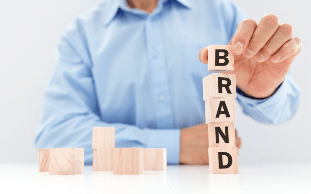 Businessman building a brand with wooden blocks