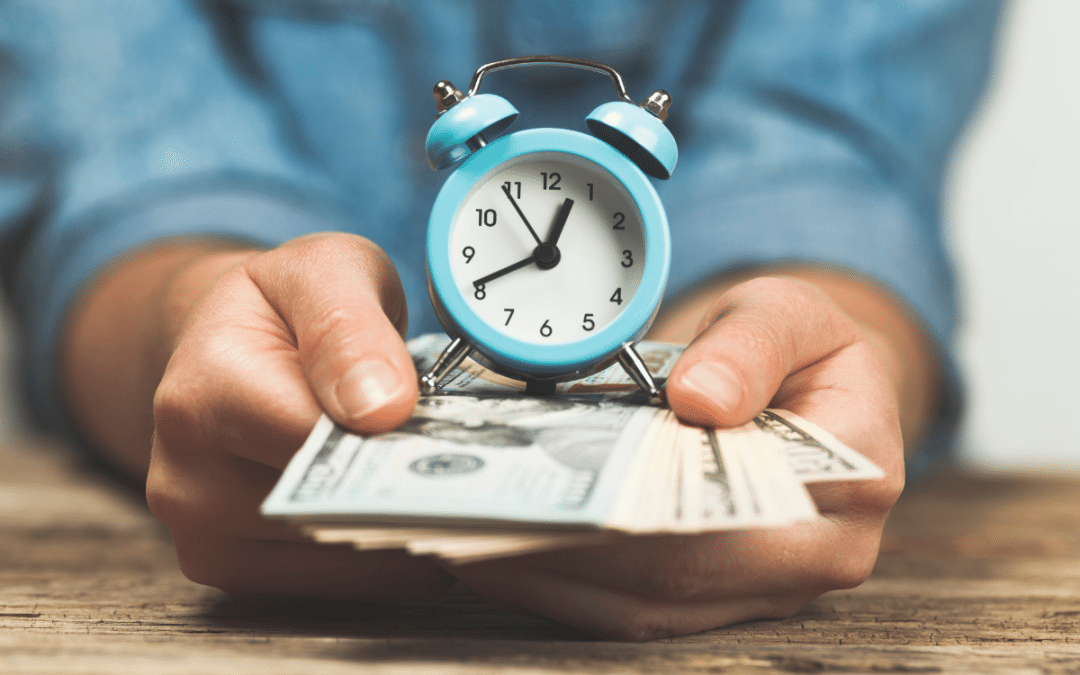 Hands holding a clock and cash, symbolizing web design hourly rates.