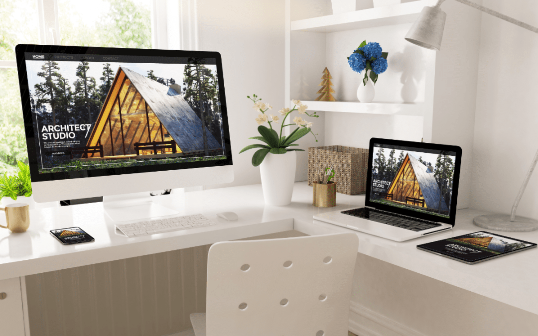 Modern workspace with desktop and laptop displaying architect studio website design.