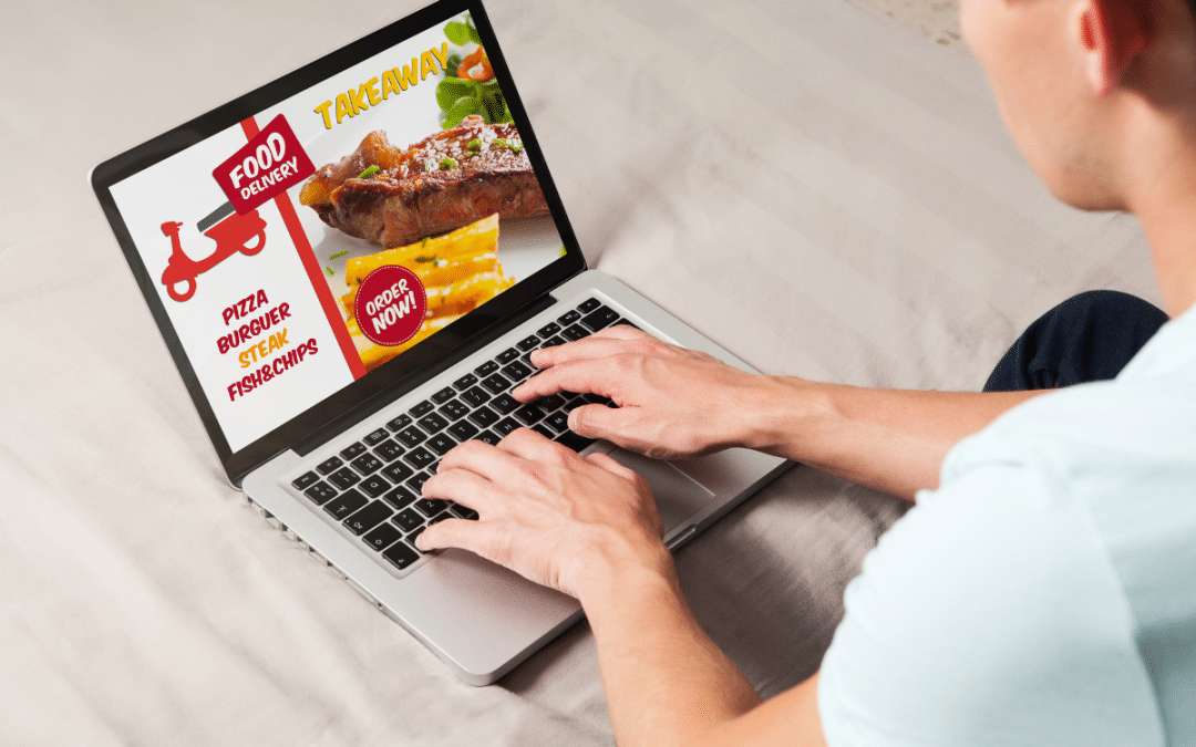 Person using laptop to order takeaway food online.