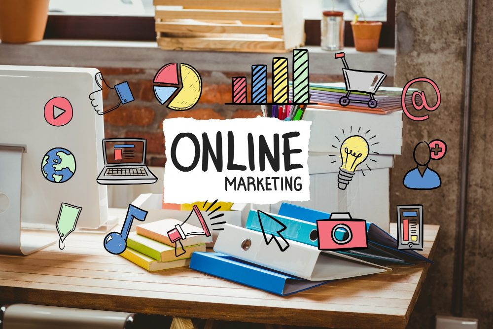 Online marketing concept with colorful icons surrounding a desk setup.