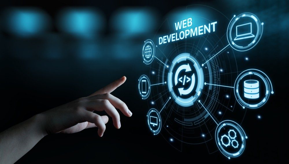 Hand reaching for digital web development icons on a futuristic interface.