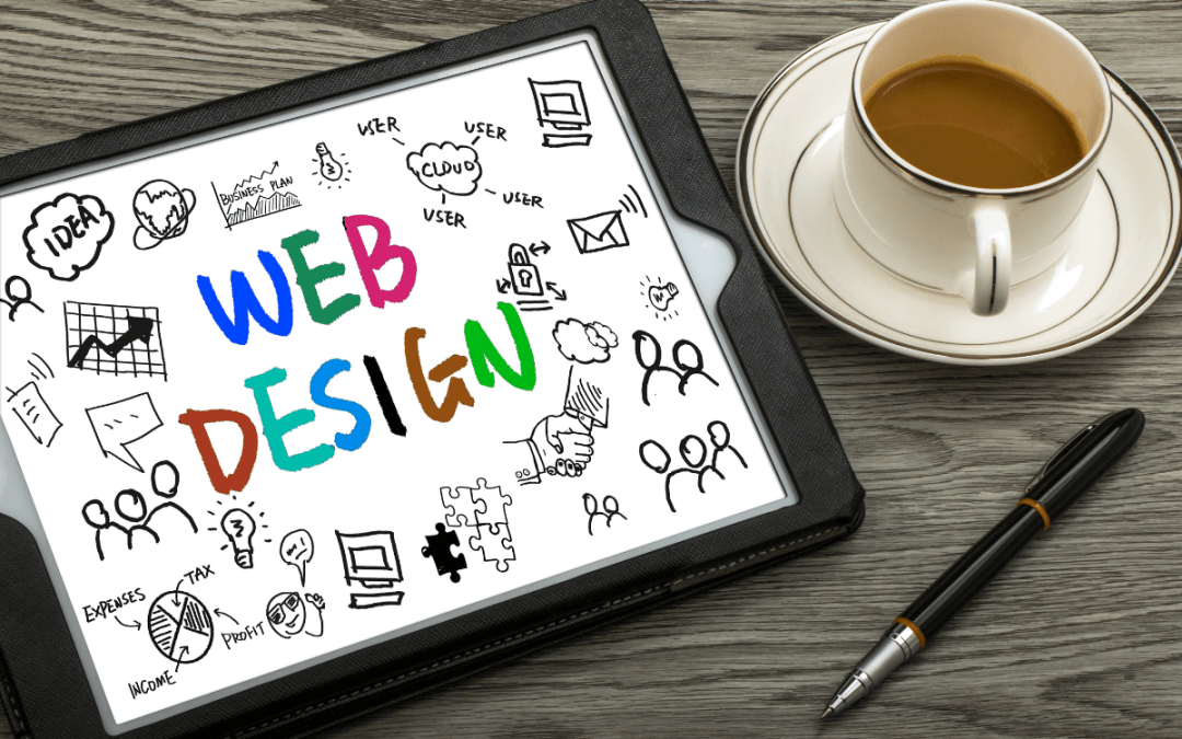iPad displaying a colorful web design graphic on a wooden table with a cup of coffee and a pen